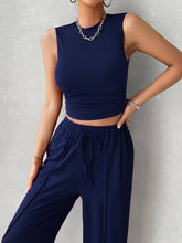 Close up front view of dark blue Zenvara set highlighting mock neck top, premium polyester/elastane blend fabric, and adjustable elastic waist detail