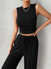 Close up front view of black Zenvara set highlighting mock neck top, premium polyester/elastane blend fabric, and adjustable elastic waist detail