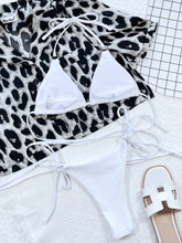 Back flat lay of white textured halter neck tie side bikini set showing adjustable top straps and side-tie bottoms