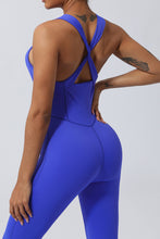 Close up rear view of blue AerisCross Vivanta Jumpsuit highlighting fabric texture and crisscross strap junction.