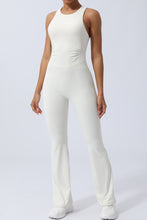 Model in white AerisCross Vivanta Jumpsuit, front view showcasing crisscross straps and sleek silhouette.