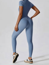 Back view of Light Blue FlowFit Jumpsuit highlighting smooth contour and sleeve fit.