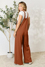 Back view of Cloudy Blue Cyrella Muse Overalls with adjustable wide straps visible.