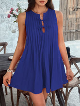 Model styling the royal blue Allurista™ mini dress at an art gallery opening.