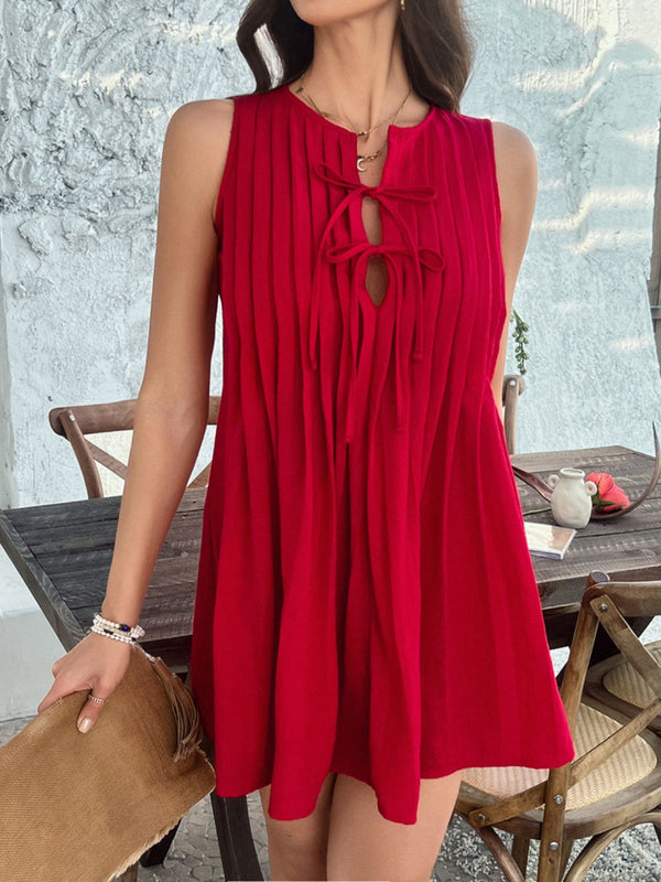 Model in scarlet Allurista™ mini dress laughing with friends at a sunset garden party surrounded by hanging lanterns.