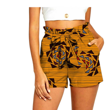 Front view of AnkaraSol HighRise Heritage Shorts in gamboge with geometric print on model.