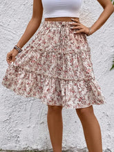 Apricot Florévyn Midi Skirt with floral print, frill tiers, and ruffled hem styled with white tube top