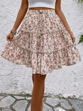 Model posing in apricot Florévyn Floral Print Midi Skirt featuring frill tiers and ruffled hem