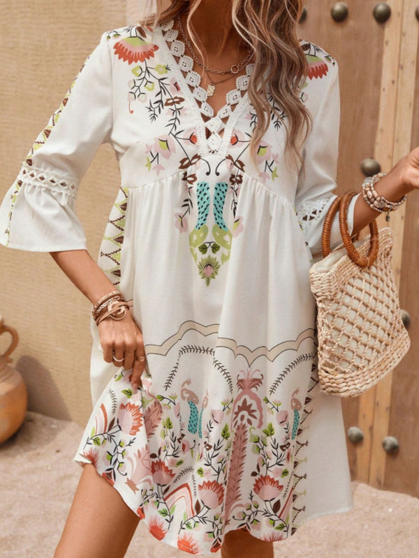 Model wearing Apricot Qelorian Lace Mini Dress styled with bronze jewelry, flat sandals, and a woven wooden round strap handbag.