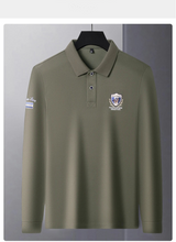 Front view of army green Equestrian Crest Designer Polo on hanger.
