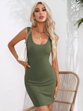 Model front view wearing the army green Curvalicious Allure Bodycon Mini Dress styled with hoop earrings, gold bangles, and neutral strappy heels.