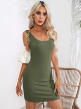 Model seated wearing the army green Curvalicious Allure Bodycon Mini Dress at a garden brunch paired with chic accessories and sandals.