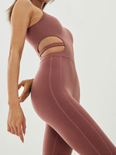 asymaflow jumpsuit brown standing backbend front close-up