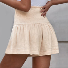 Apricot pleated high elastic waist textured shorts back view.