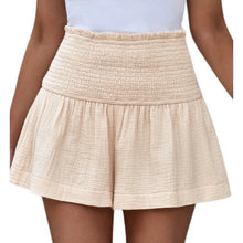 Apricot pleated high elastic waist textured shorts front view.