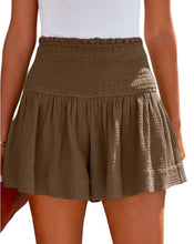Brown pleated high elastic waist textured shorts front view.