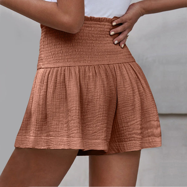 Cameo pink pleated high elastic waist textured shorts back view.