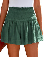Dark green pleated high elastic waist textured shorts front view.