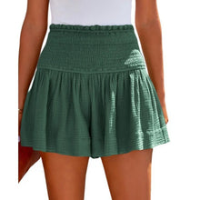Dark green pleated high elastic waist textured shorts side angle.