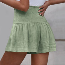 Light green pleated high elastic waist textured shorts back view.