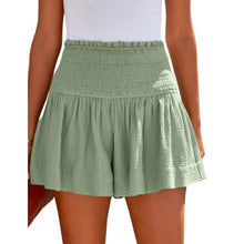 Light green pleated high elastic waist textured shorts front view.