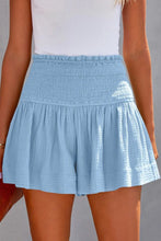 Sky blue pleated high elastic waist textured shorts front view.