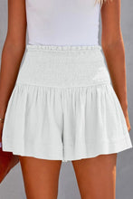 White pleated high elastic waist textured shorts front view.