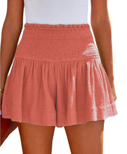 Person wearing a coral smocked skirt  front view.
