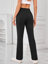 Back view of AuriCore Flexion Black Pocket Pants highlighting snug high-waist fit.