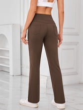 Back view of AuriCore Flexion Brown Pocket Pants highlighting snug high-waist fit.