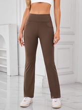 Model wearing AuriCore Flexion Brown Pocket Pants, front view showcasing high waist and side pockets.