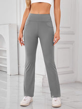 Model wearing AuriCore Flexion Gray Pocket Pants, front view showcasing high waist and side pockets.