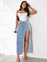 Full body view of model pose in light blue Averlynn Curve Skirt styled holding a coffee cup
