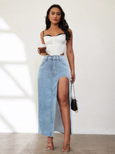 Full body view of model in light blue Averlynn Curve Skirt styled with white corset, black shoulder purse, and holding a coffee cup