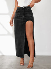Side view close-up of Averlynn Curve Skirt in black showcasing curved side slit and exposed seams