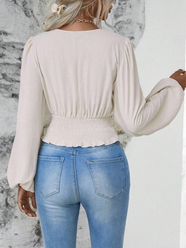 Back view illustrating the beige Balloonique blouse's fit and design.