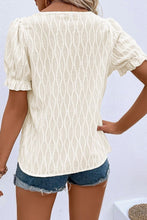 Back view displaying the cream blouse's overall fit and texture.