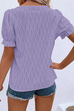 Back view displaying the lavender blouse's overall fit and texture.