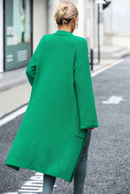 Back view of mid green cardigan showing flowy, relaxed silhouette