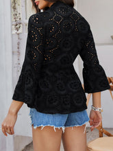 Back view of Luméa™ Blouse in Black, highlighting the peplum silhouette, accessorized with gold jewelry and heels.