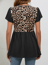 Back view of black leopard print babydoll blouse with flutter sleeves and a softly gathered waistline for a relaxed, flowy silhouette.