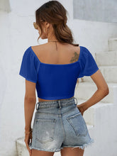 Back view of Glowflutter Crop Top in royal blue.