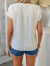 Back view displaying the white CrochetCharm Top's back button closure and overall design.