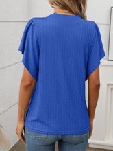 Back view of the Round Neck Flutter Sleeve T-Shirt in royal blue, showing relaxed fit and flutter sleeve detail, paired with denim shorts.