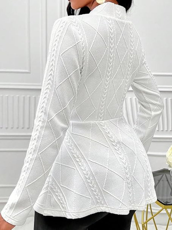 A woman showcasing the back of a white One Button Textured Peplum Cardigan at a casino in Los Vegas.