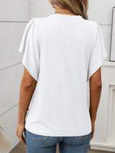 Back view of the Round Neck Flutter Sleeve T-Shirt in white showing relaxed fit and flutter sleeve detail, paired with denim shorts.