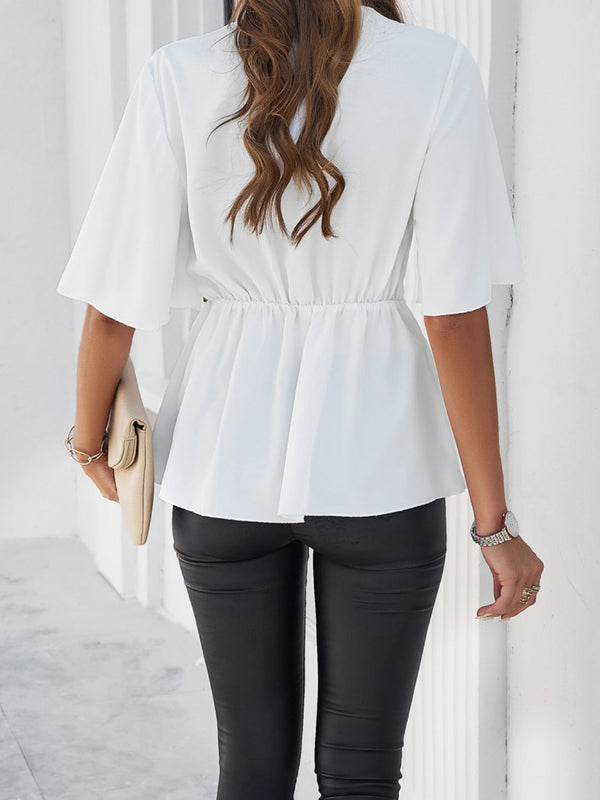 Back view of model showcasing the white peplum hem and relaxed fit of the tied front blouse, paired with slim-fit jeans.