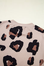 Back view close-up of soft Mocha leopard print fabric texture and round neckline stitching details, showcasing material quality.