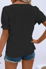 Back view displaying the black blouse's overall fit and texture.