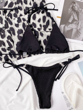 Back flat lay of black textured halter neck tie side bikini set showing adjustable top straps and side-tie bottoms